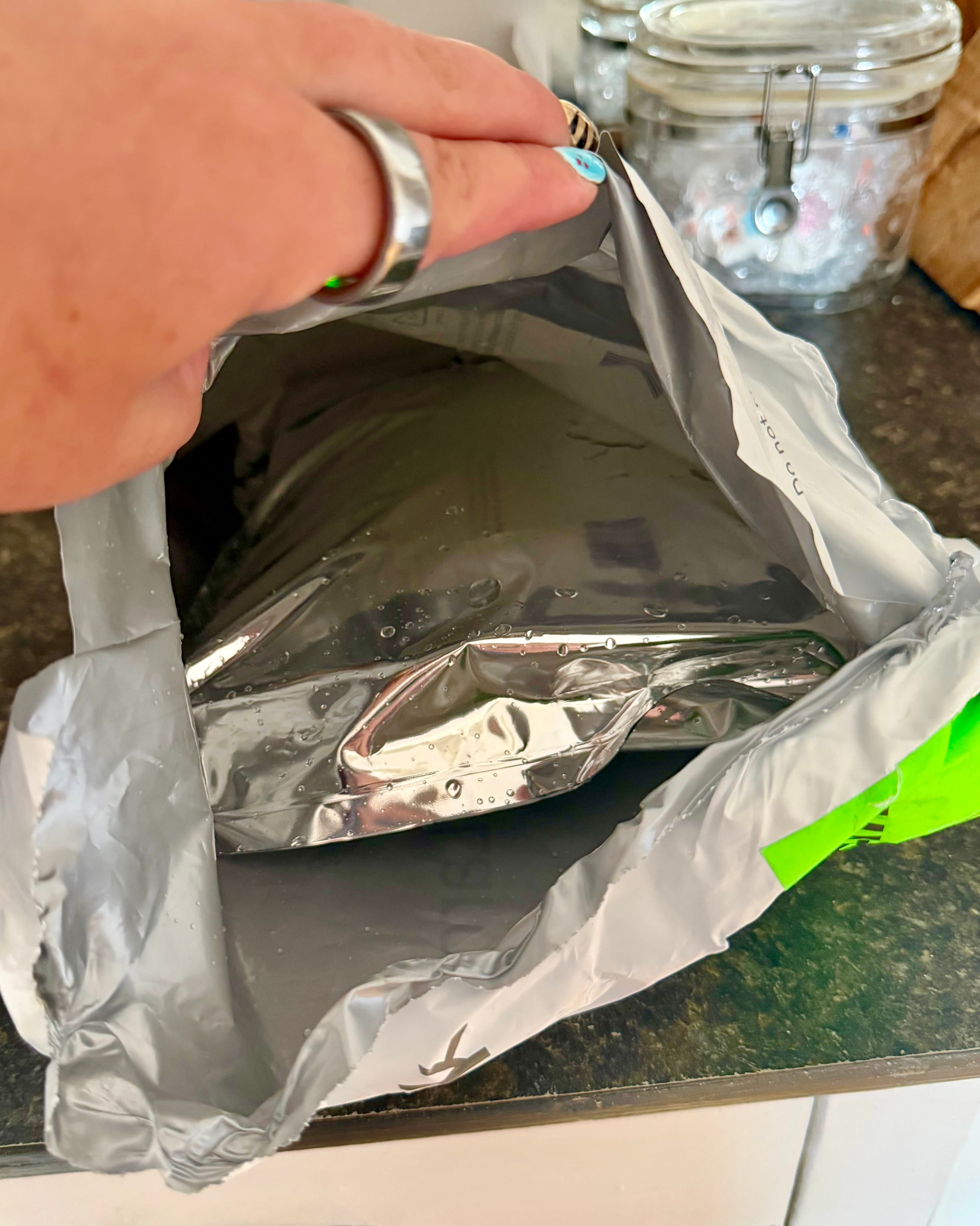 Inside of the AltRx shipping envelope showing an insulated foil liner and two gel ice packs around the medication pouch