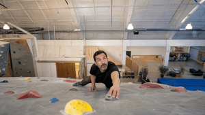 hispanic man climbing in the gym