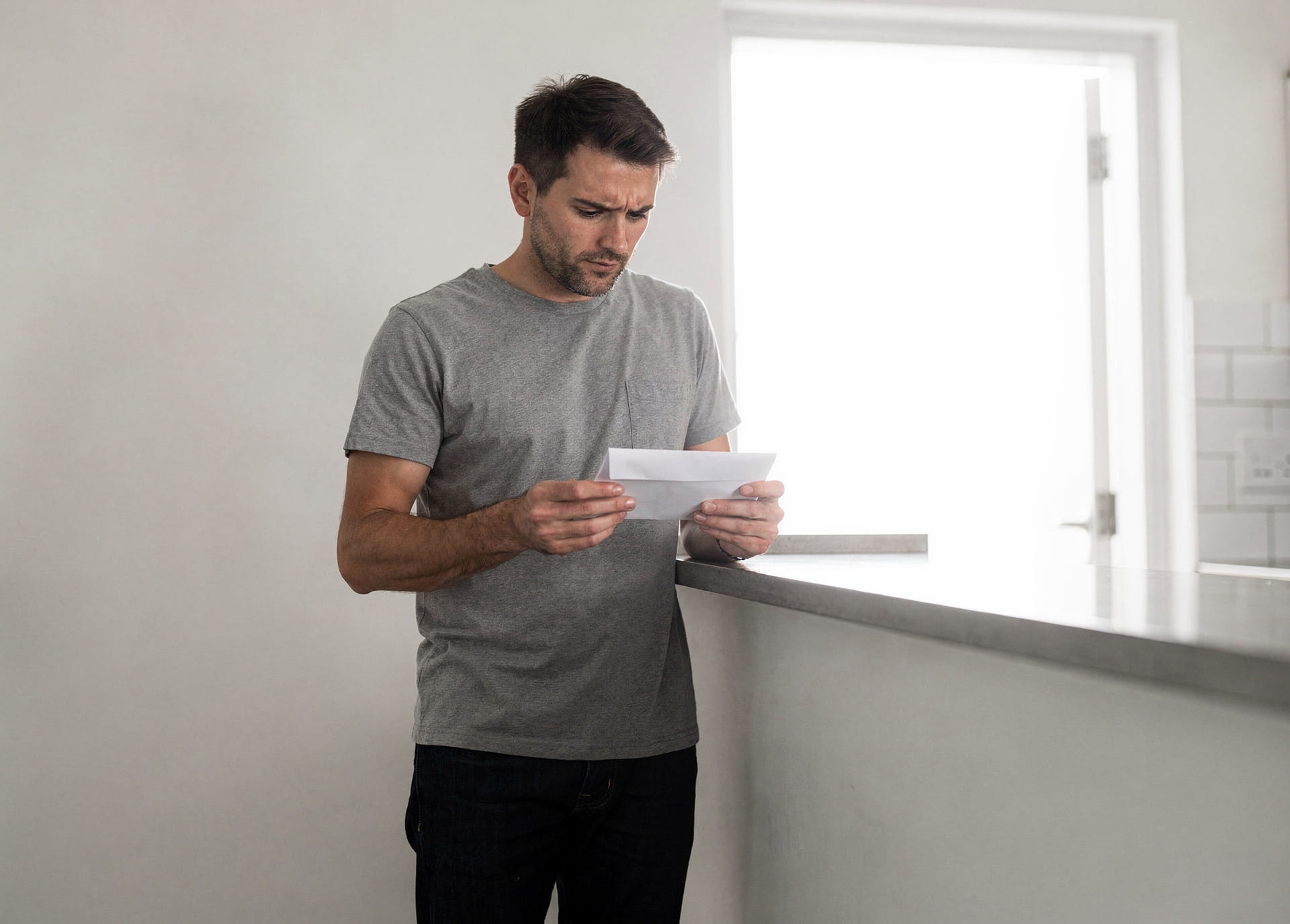 man-reviewing-paperwork-in-house.jpg