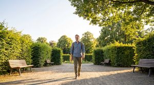 man-walking-park-path