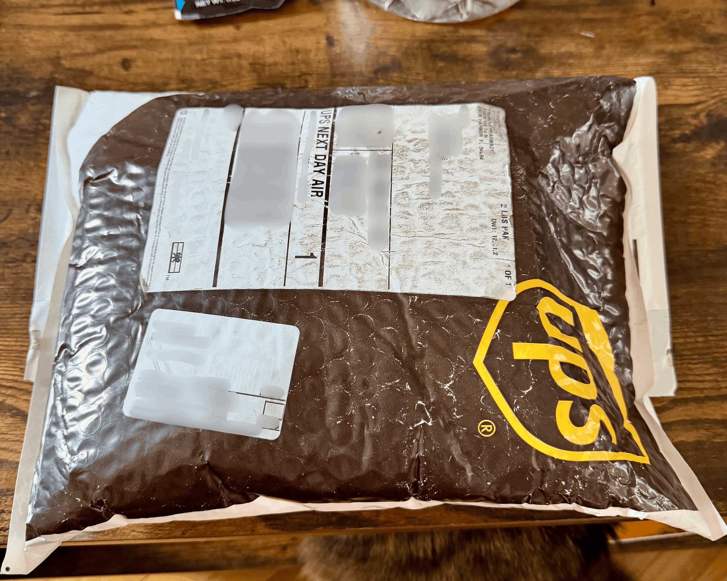 Compounded tirzepatide order arriving in a UPS Next Day Air padded mailer shipped from Promise Pharmacy in Palm Harbor Florida
