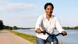 woman-riding-bike-along-canal