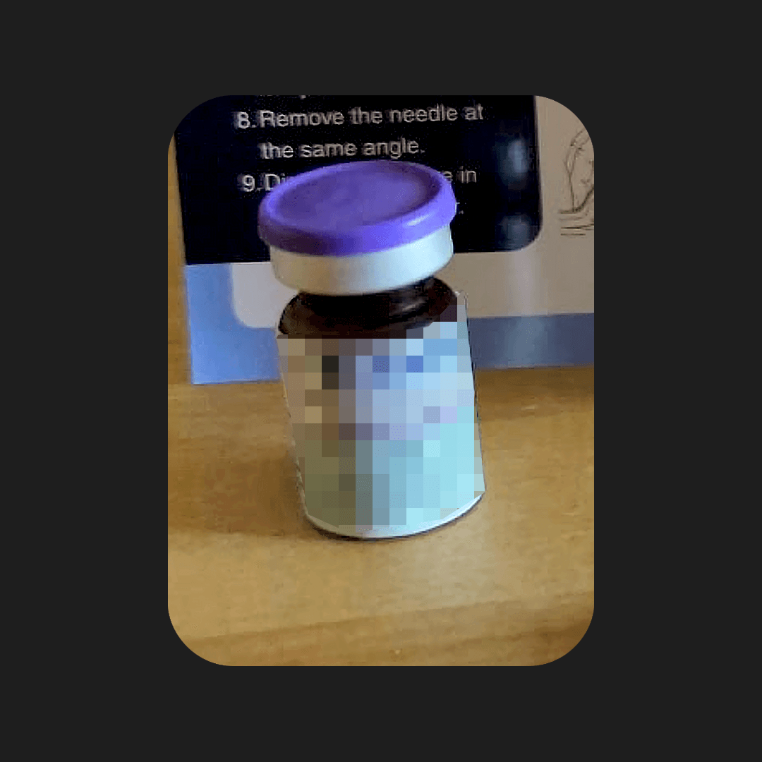 Close-up of the Fridays compounded tirzepatide vial with pyridoxine and L-carnitine, amber glass with a purple flip-top cap