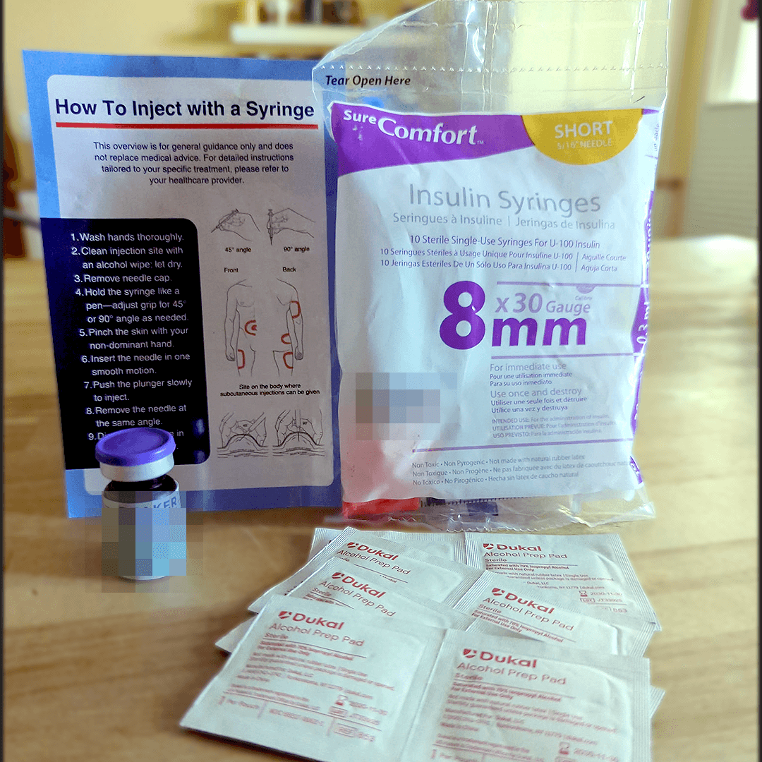 Fridays kit contents laid out: 8mm 30-gauge insulin syringes, alcohol prep pads, and the compounded tirzepatide vial