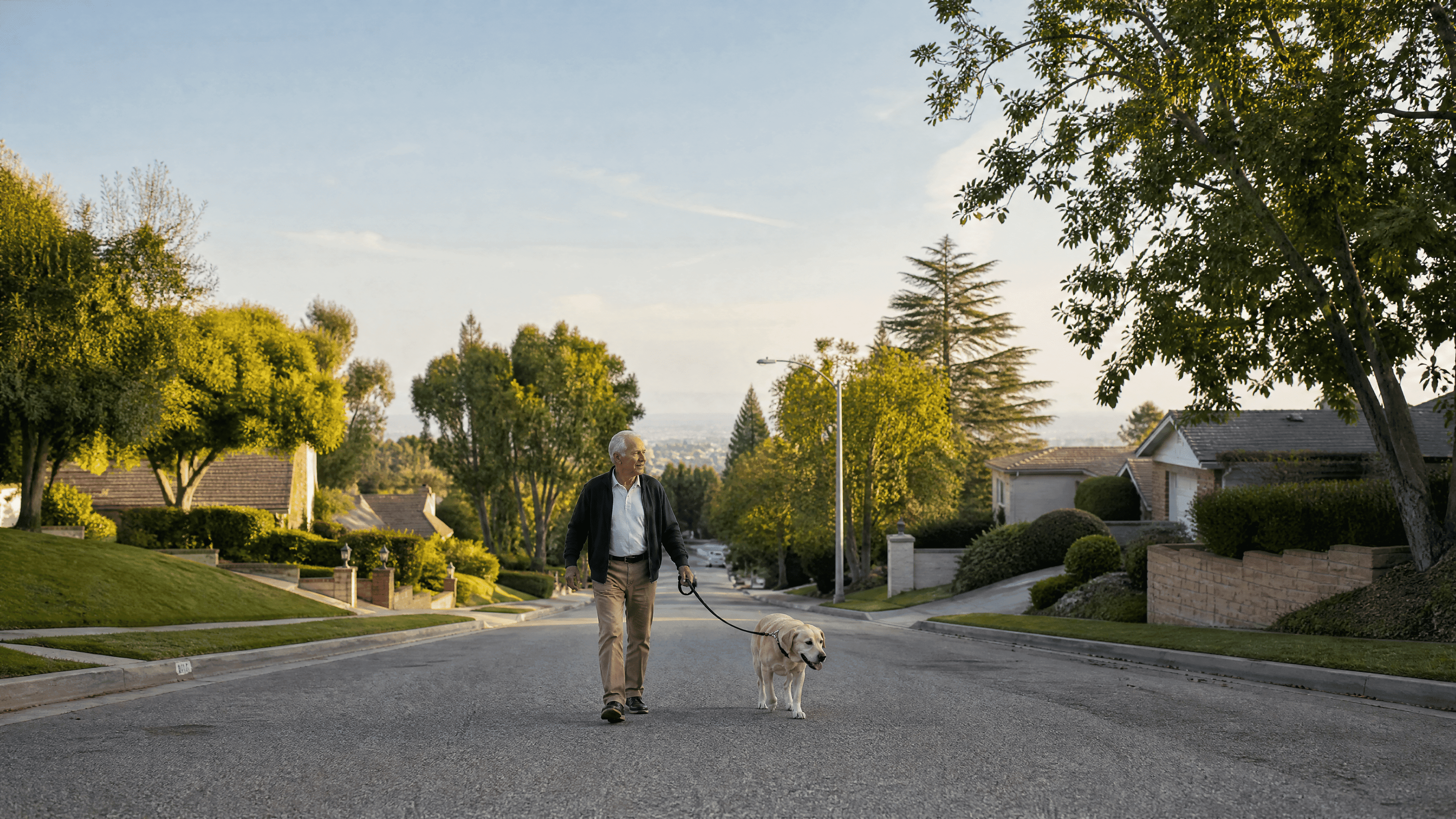man in his late 60s walking his dog