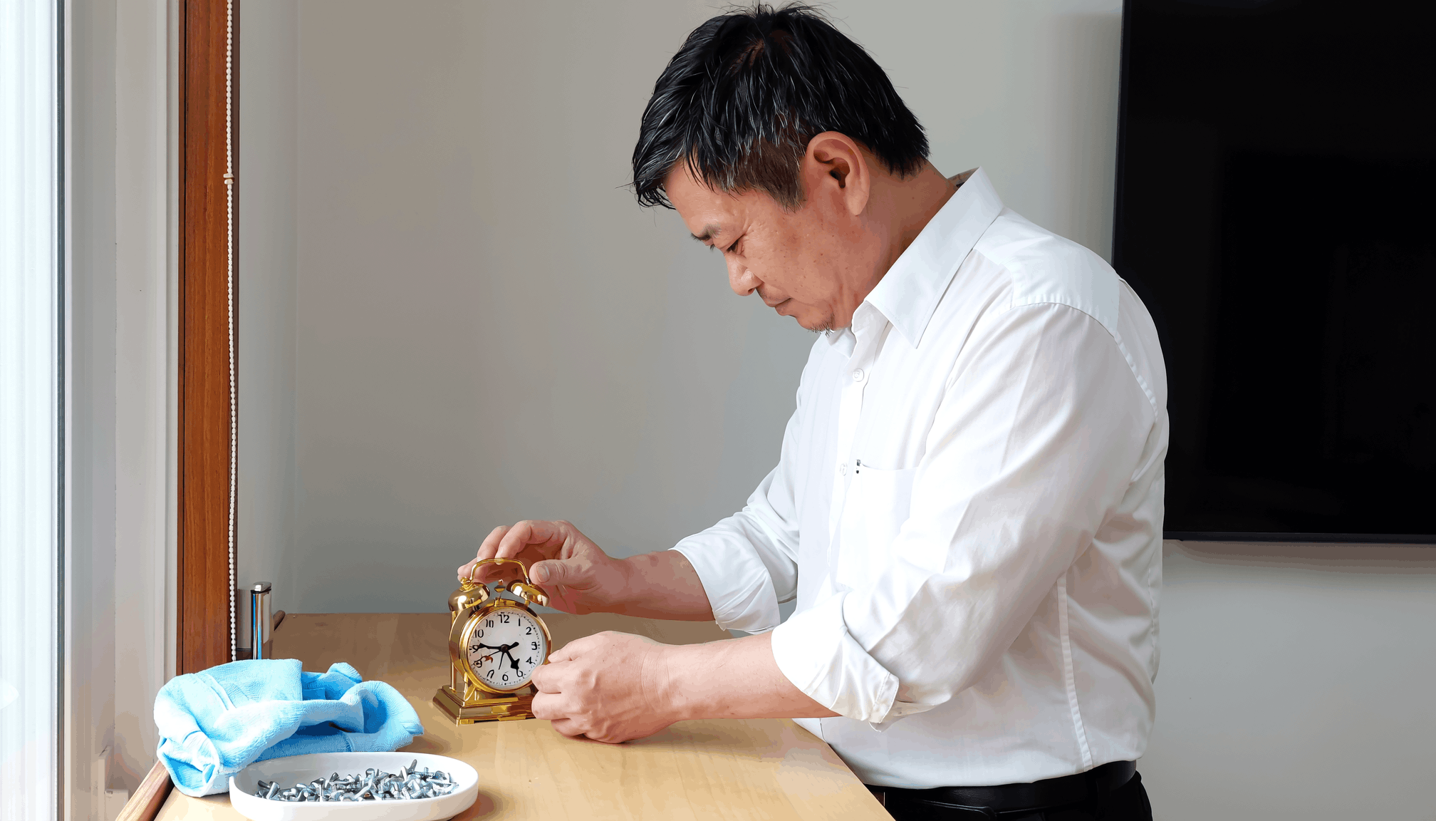 man-fixing-clock-at-counter.png