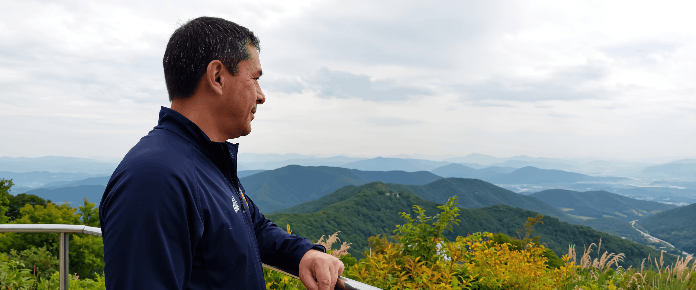 man-overlooking-mountain-view.png