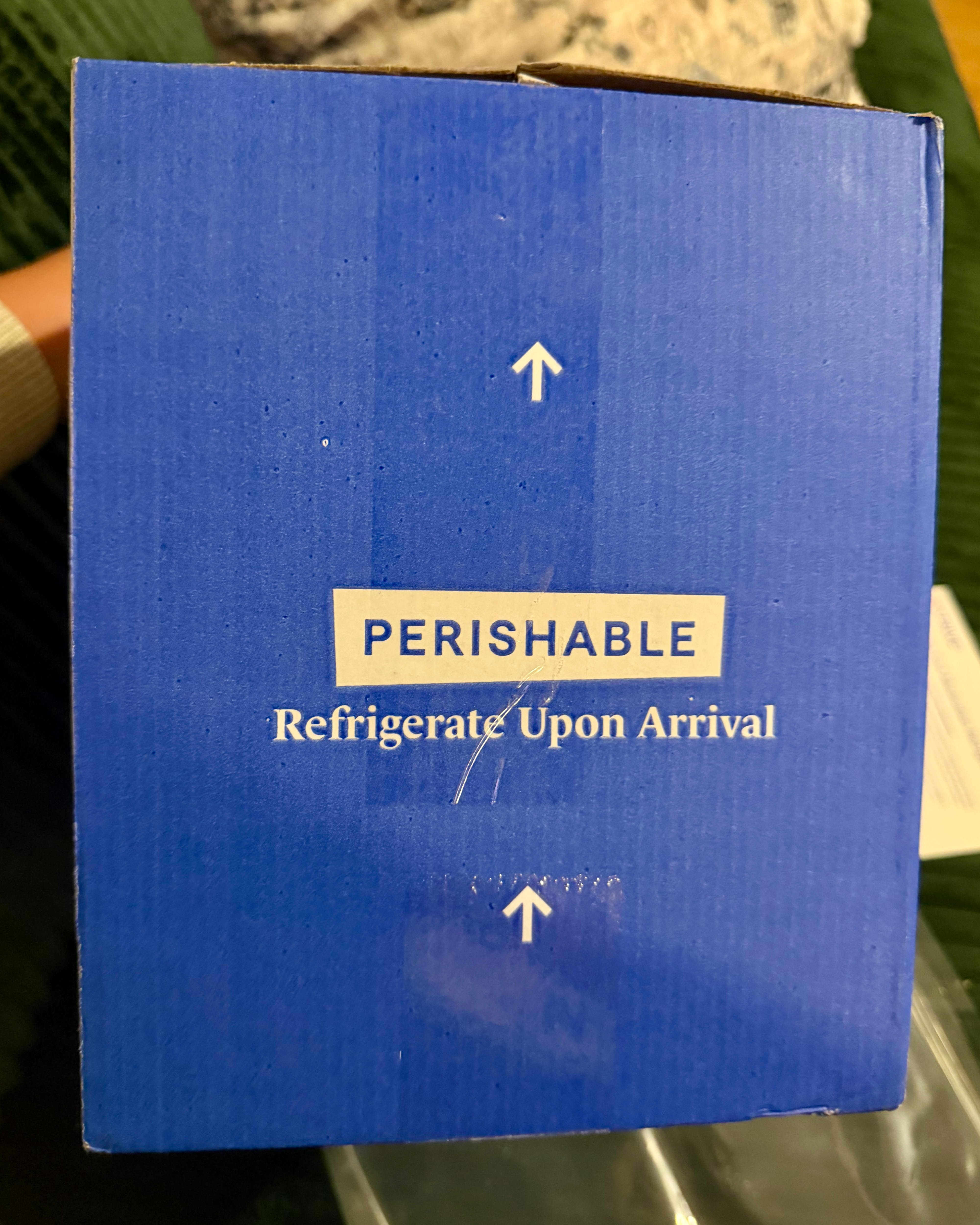 Blue corrugated Strive Pharmacy shipping box side panel printed PERISHABLE Refrigerate Upon Arrival with this-way-up arrows