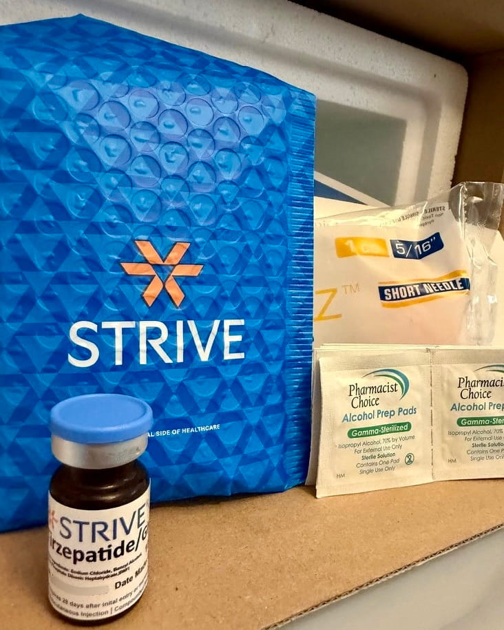 The vial and all shipping packaging laying out in a single image.
