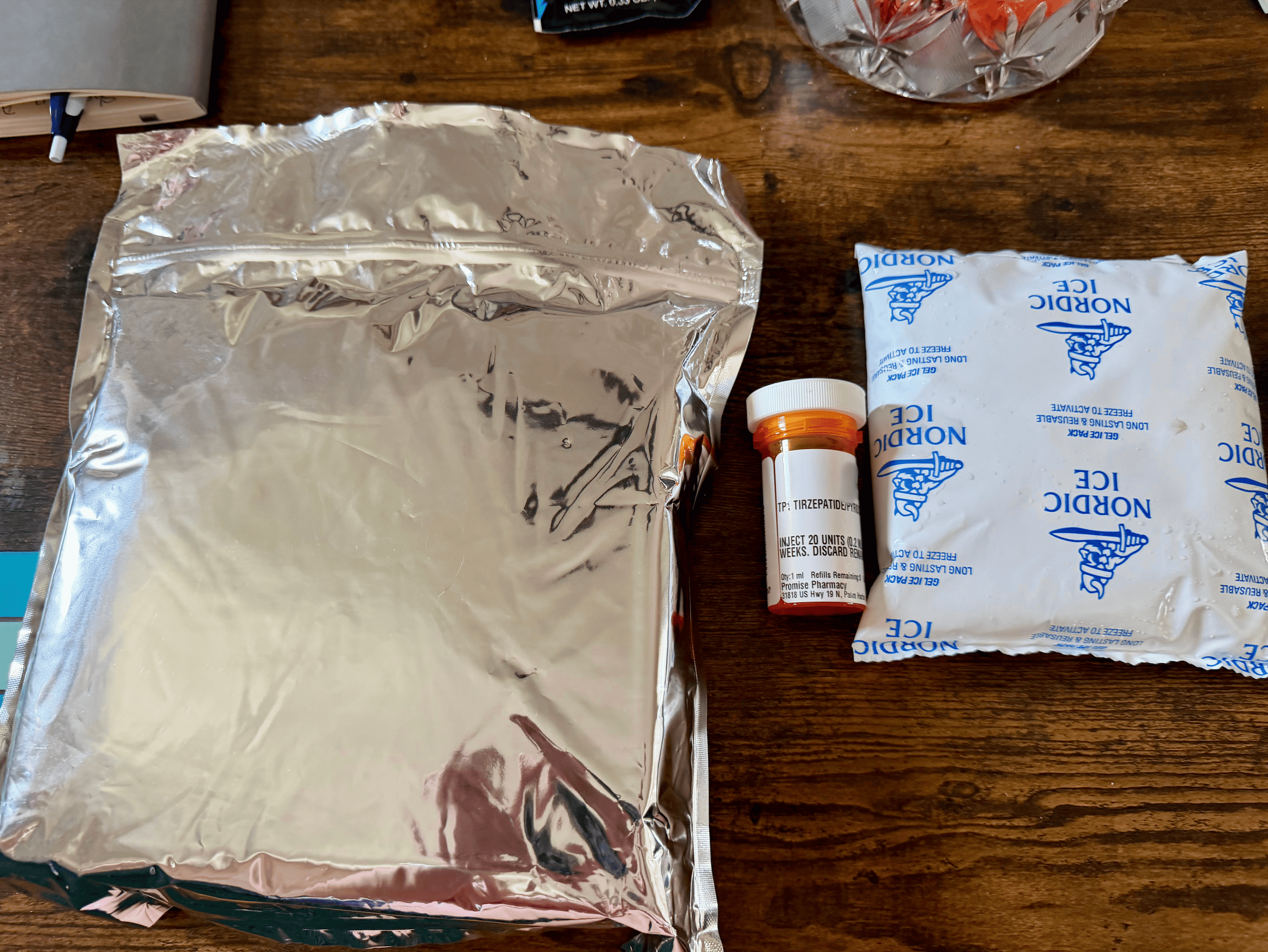 Shed mylar pouch with the pharmacy bottle and Nordic Ice gel pack laid out on a table