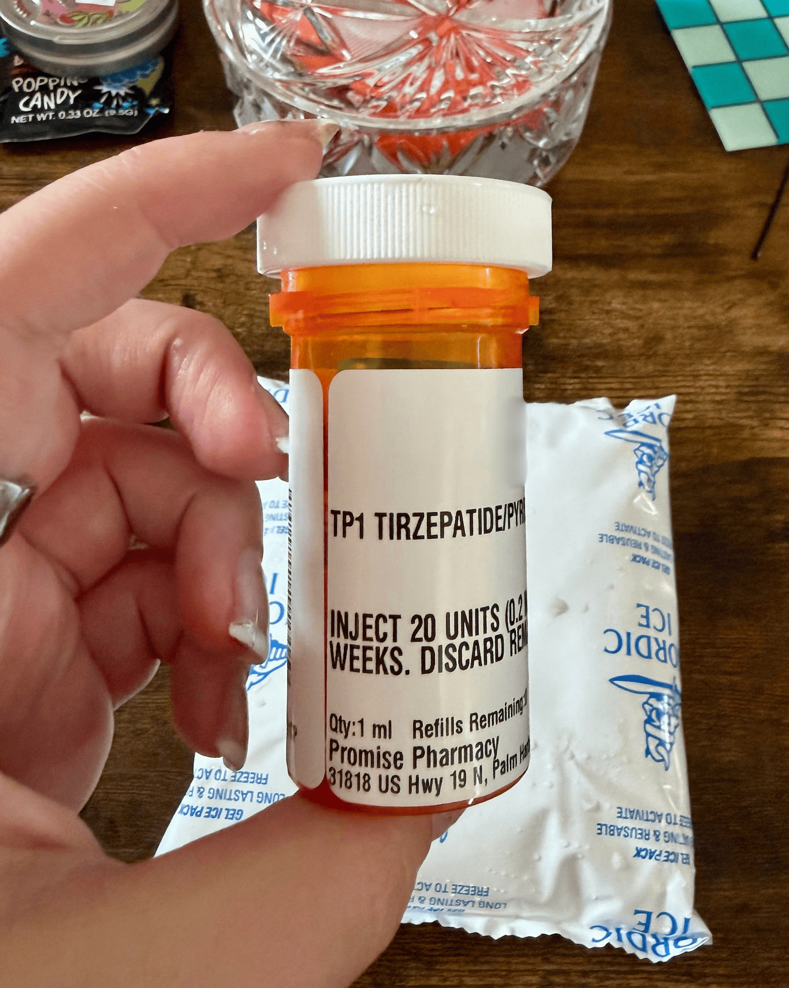 Shed pharmacy bottle labelled TP1 tirzepatide pyridoxine with directions to inject 20 units weekly, from Promise Pharmacy