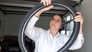 woman-checking-out-bike-tire.png