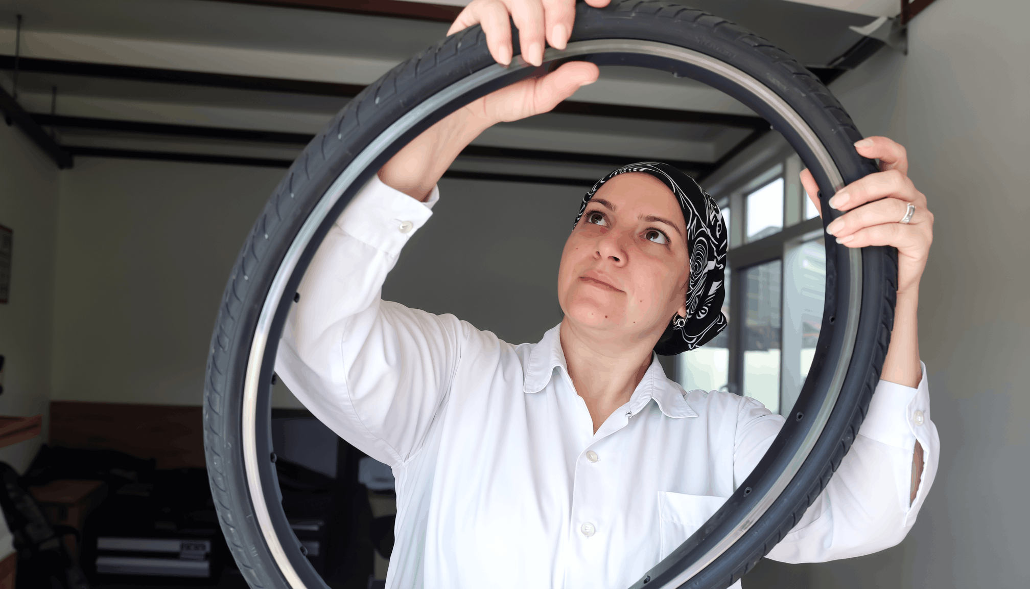 woman-checking-out-bike-tire.png