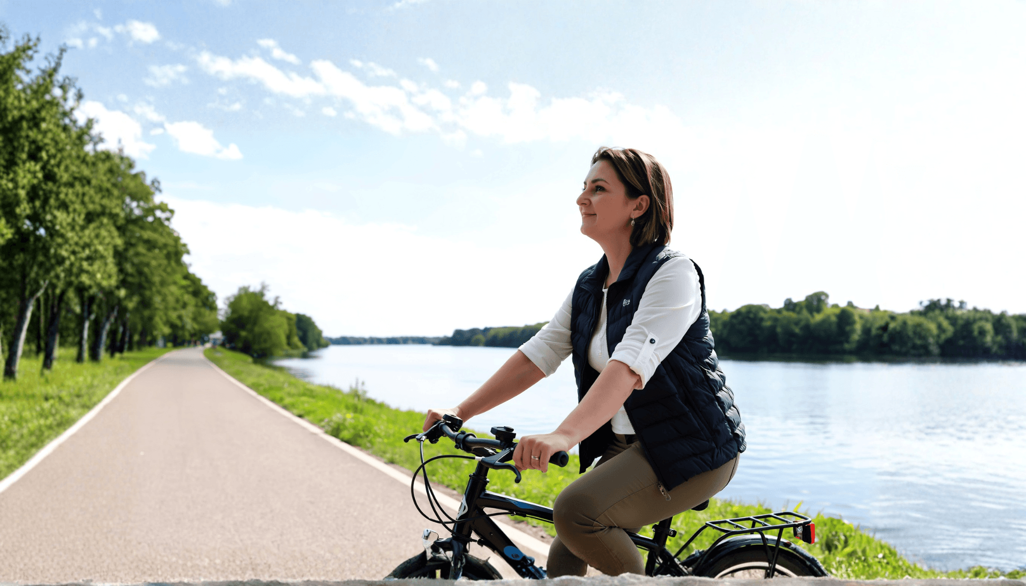 woman-riding-bike-in-park.png
